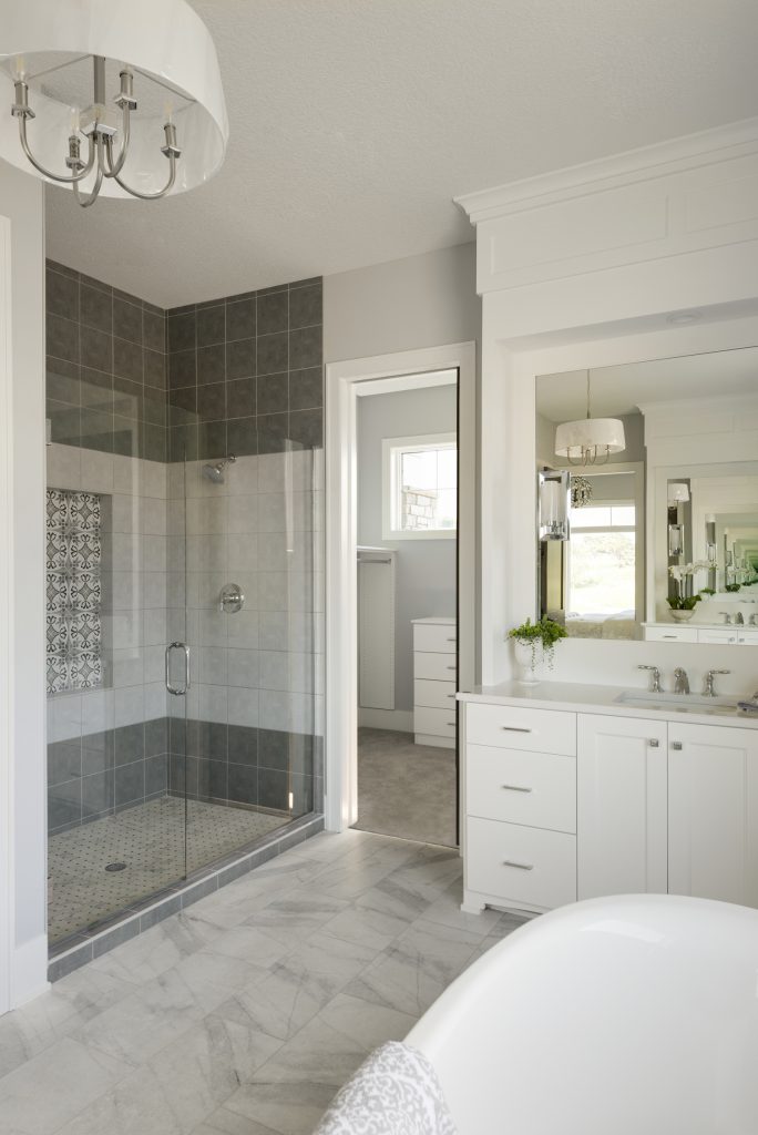 master bathroom with custom tile shower, soaker tub and white vanity